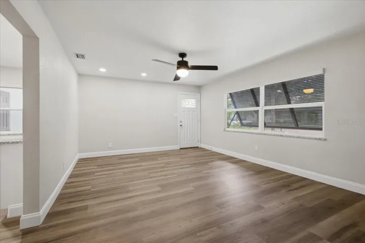 Spacious Living Room with Hurricane Shutters &amp; Remote-Controlled Blinds Throughout