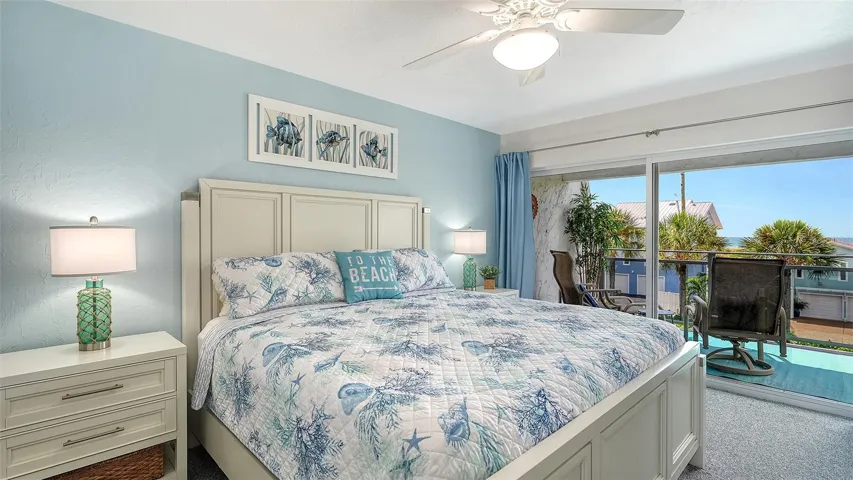 Large Primary Bedroom with a King Size bed, Walk in Closet, and sliders to the balcony.