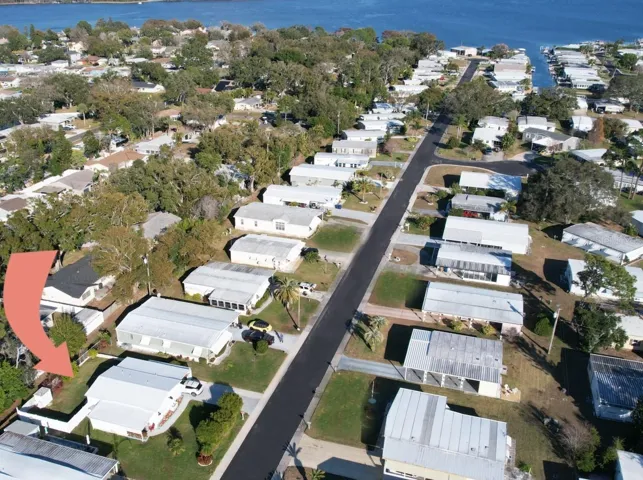 Rare 2% find! Aerial view of the property with a fenced backyard, steps away from beautiful Lake Tarpon.