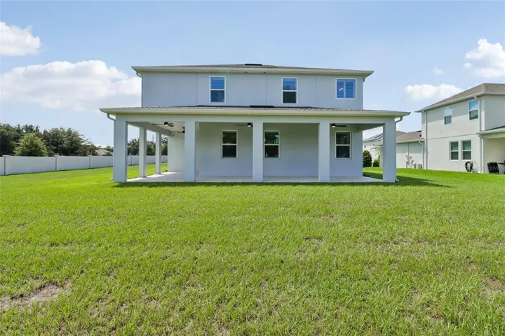 Wrap around lanai overlooks a large yard.