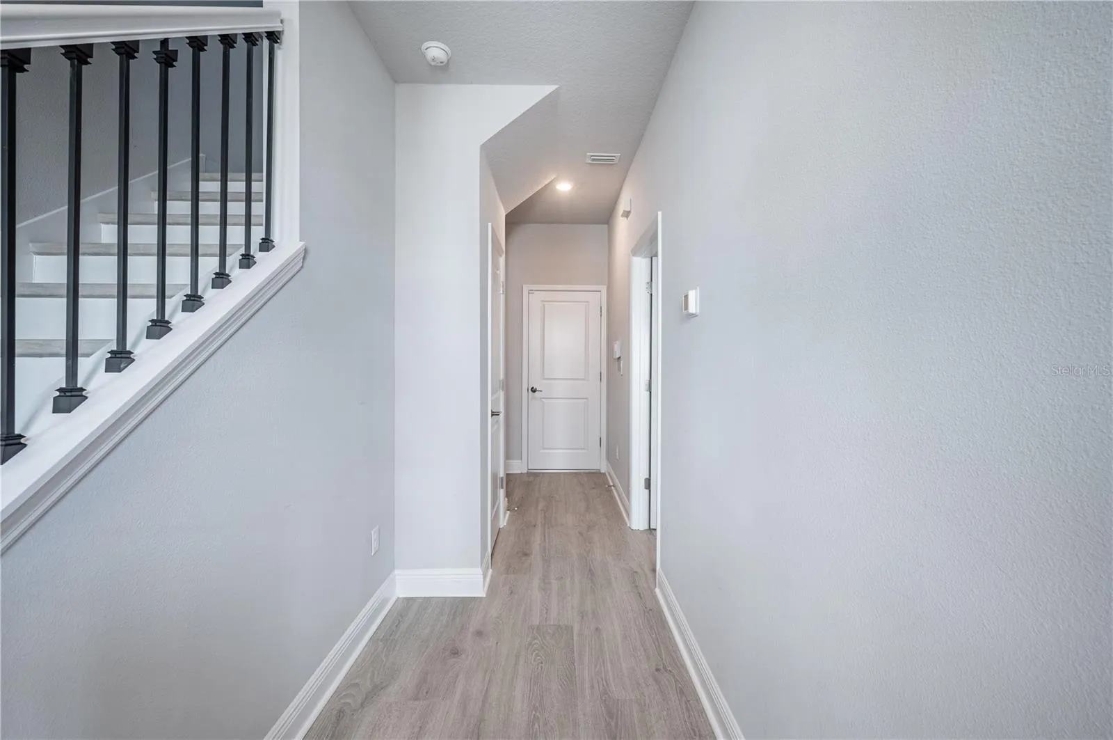 Looking down the hall toward the 'mud room' on the left and the garage straight ahead...