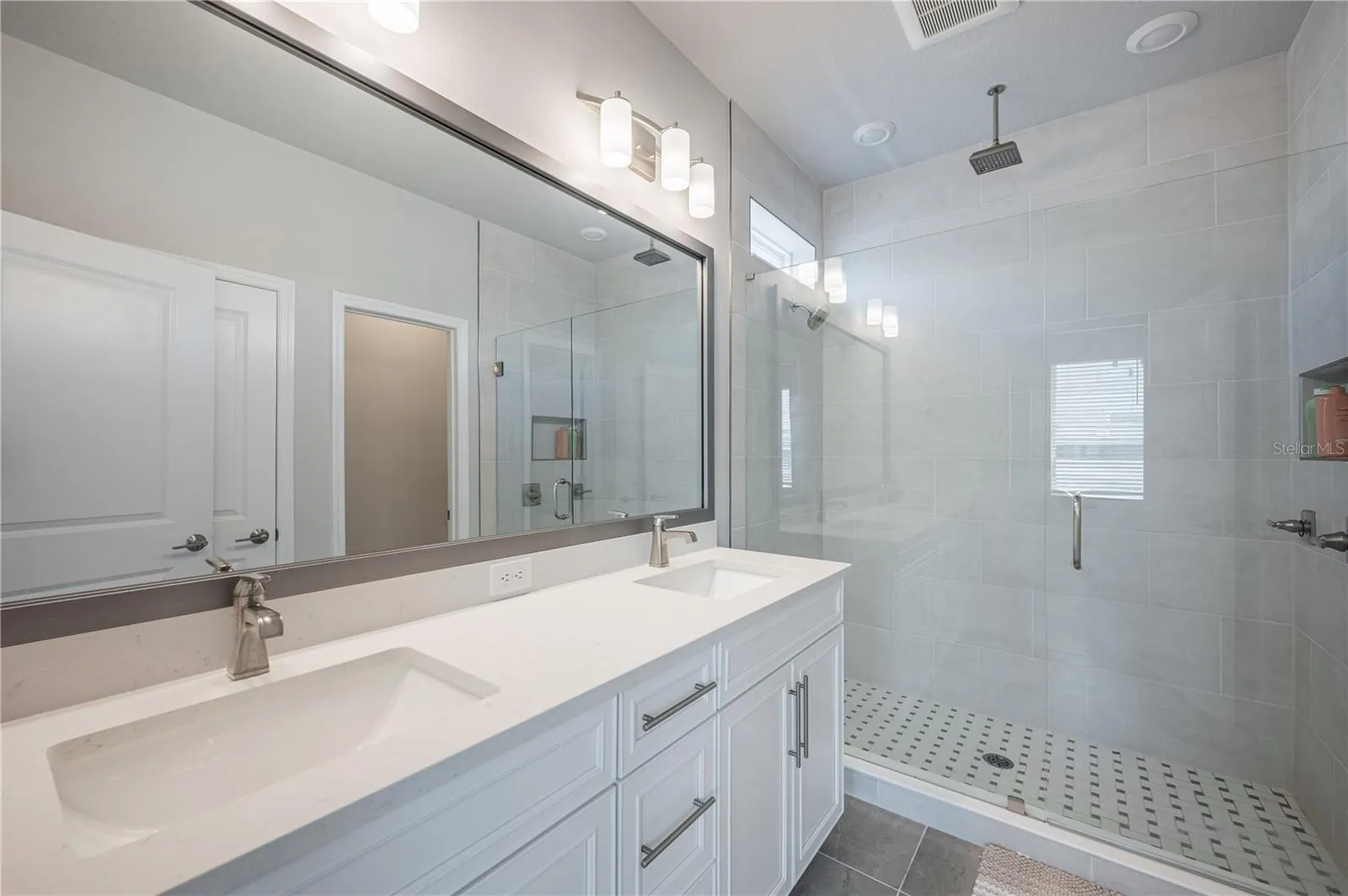 Dual vanity. Shower with multiple heads.