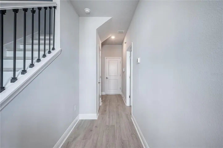 Looking down the hall toward the 'mud room' on the left and the garage straight ahead...