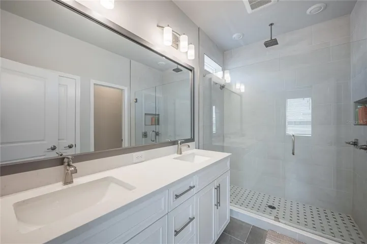 Dual vanity. Shower with multiple heads.