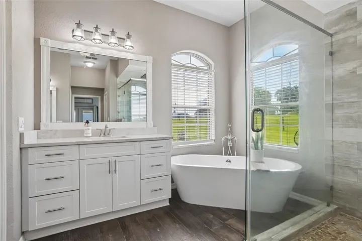 Primary Bathroom with dual vanities, makeup area,  soaking tub and new seamless shower glass