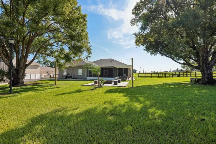 Back of home with beautiful pavers, seating area and fire pit