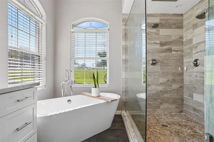 Primary Bathroom with dual vanities, makeup area,  soaking tub and new seamless shower glass
