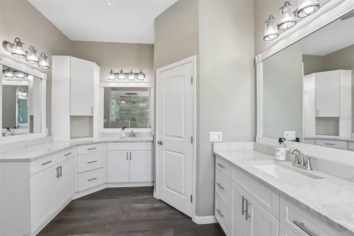 Primary Bathroom with dual vanities, makeup area,  soaking tub and new seamless shower glass