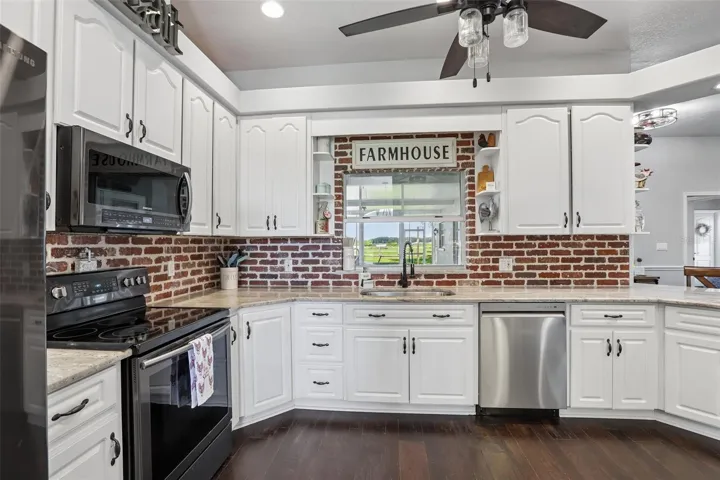 Kitchen with 42" cabinets, granite and brick backsplash