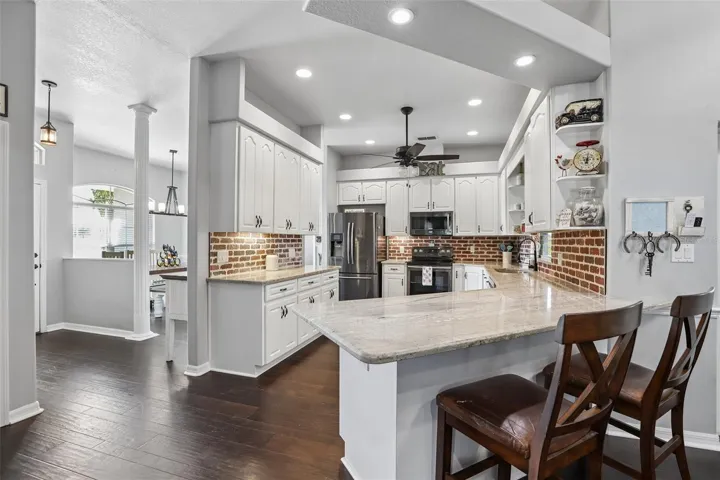 Kitchen with 42" cabinets, granite and brick backsplash