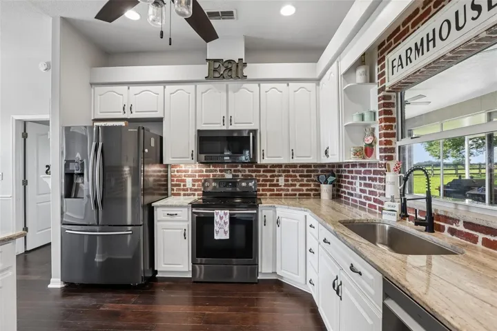 Kitchen with 42" cabinets, granite and brick backsplash