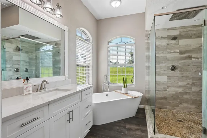 Primary Bathroom with dual vanities, makeup area,  soaking tub and new seamless shower glass