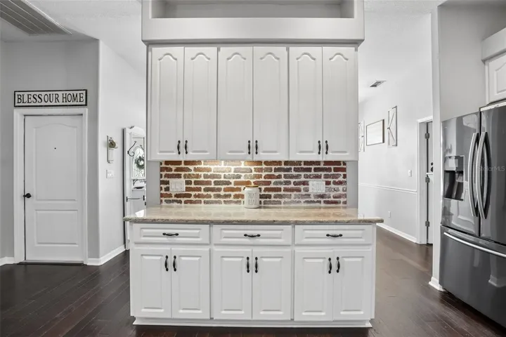 Kitchen with 42" cabinets, granite and brick backsplash