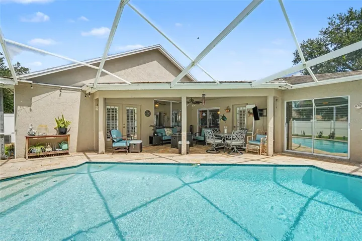 Florida Life at its best! Sparkling Pool surrounded by lovely landscaping