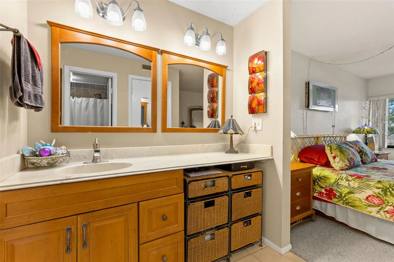 The primary bath includes a long vanity with generous counter space, dual mirrors and a separate makeup area with room for seating.