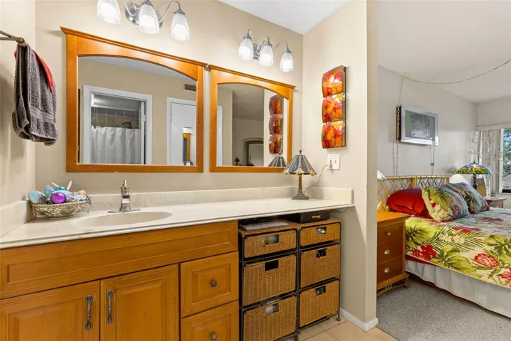 The primary bath includes a long vanity with generous counter space, dual mirrors and a separate makeup area with room for seating.