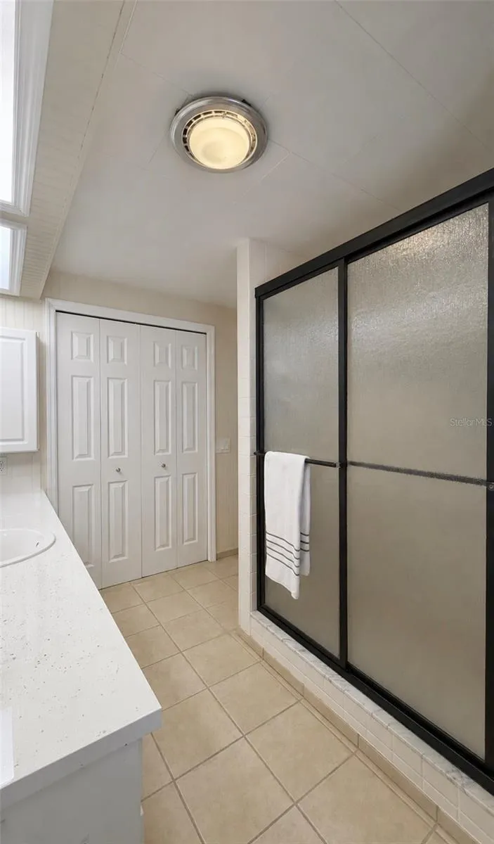 Primary bathroom with a full size closet