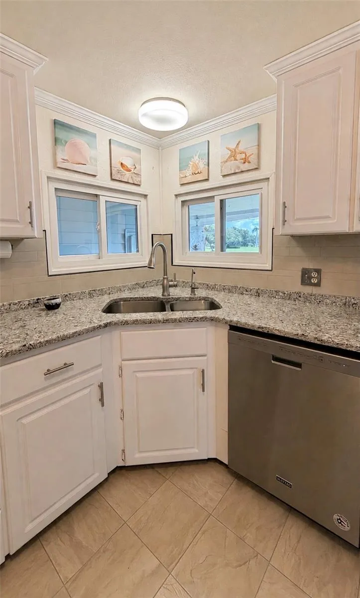 Sink in kitchen looks out to patio.