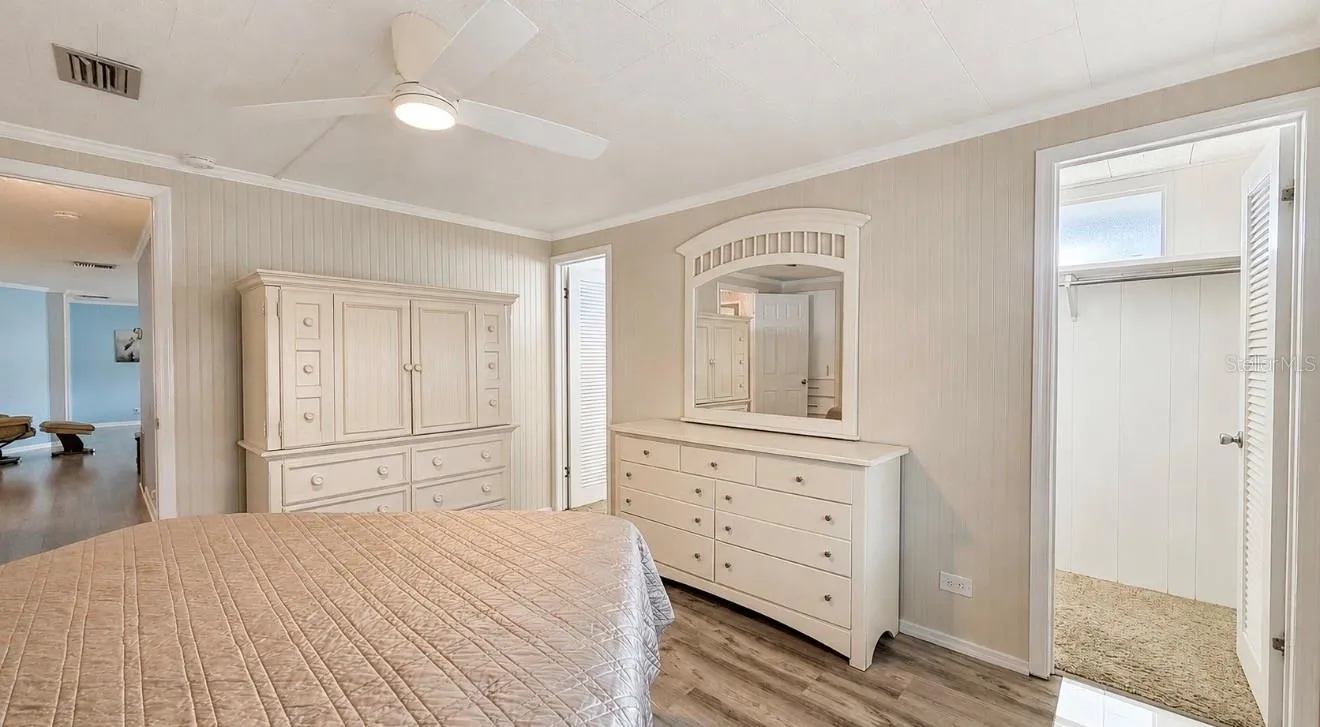 Primary bedroom with 2 doors to walk in/walk through closet