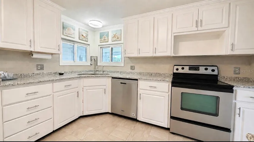 kitchen with windows over the sink to look out patio to golf course