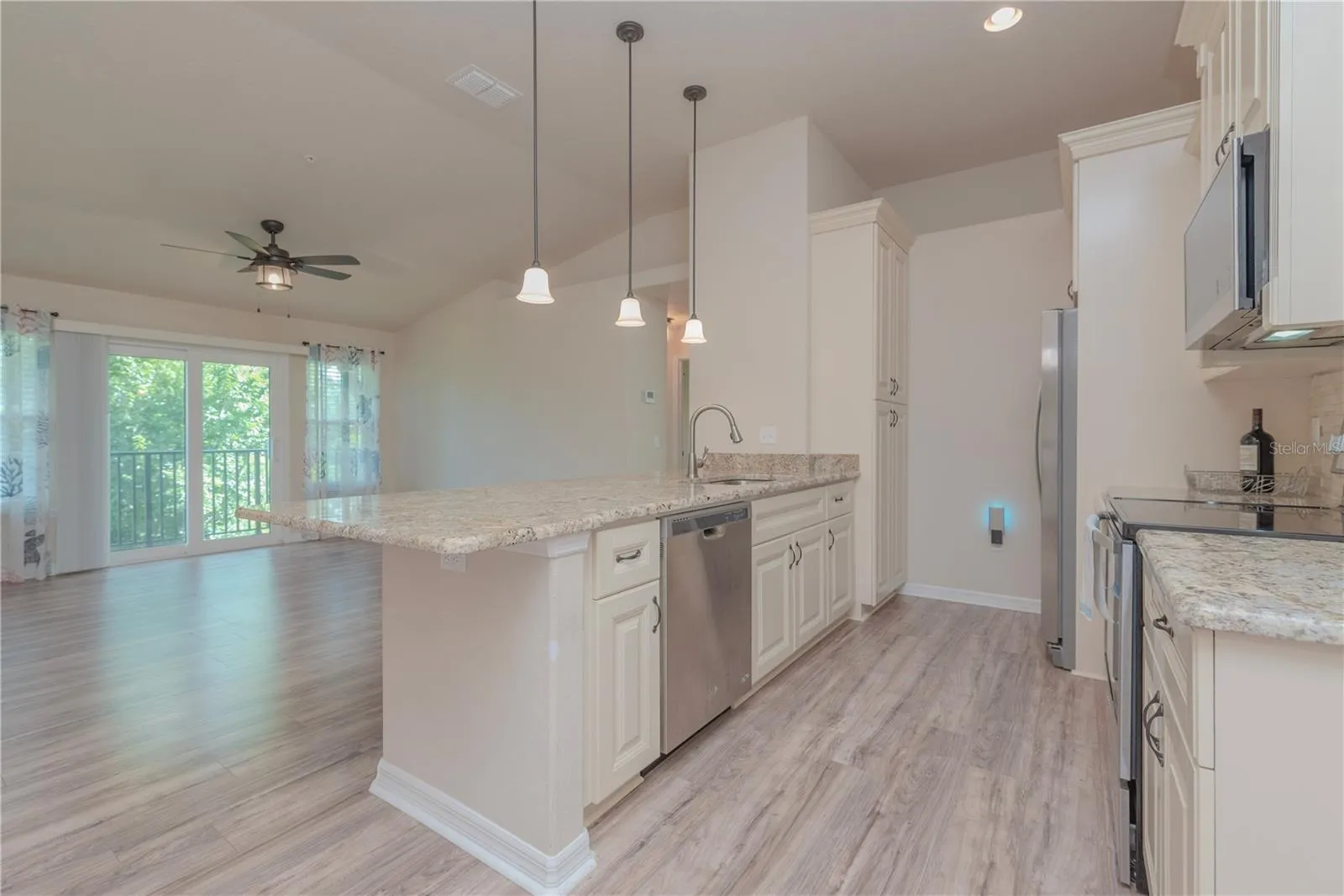 Kitchen with stainless steel appliances and closet pantry.