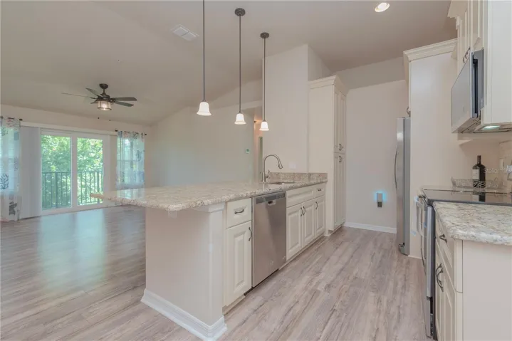 Kitchen with stainless steel appliances and closet pantry.