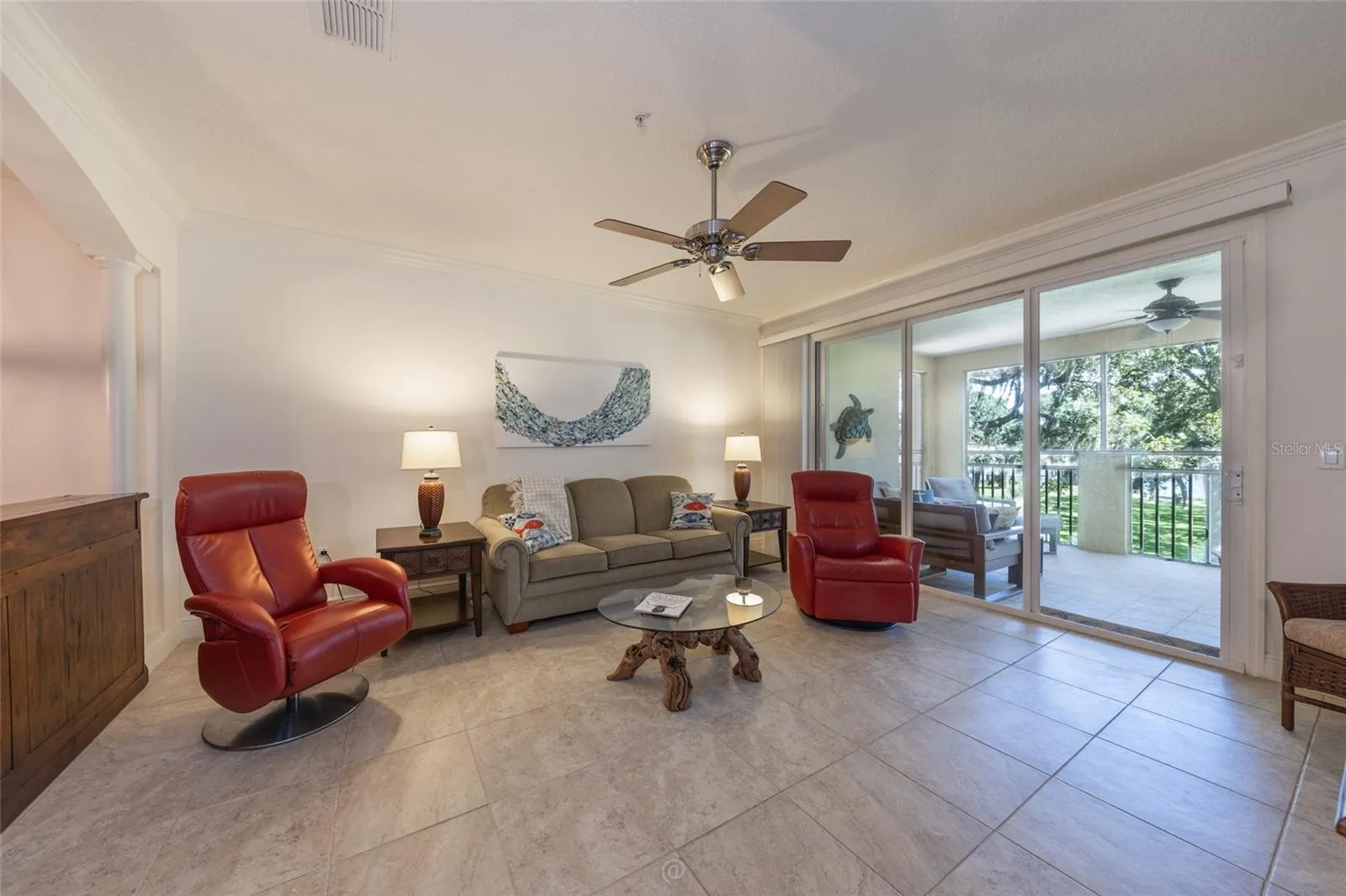 TITLED LIVING AREA WITH SLIDERS THAT OPEN TO SCREENED PATIO