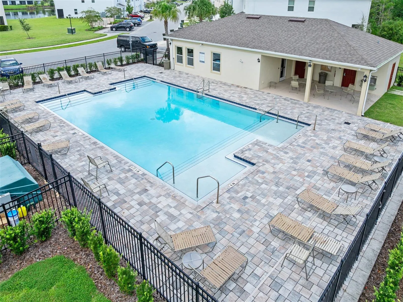 Community pool with lounge chairs and covered seating