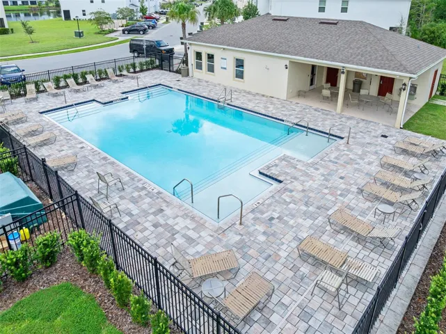 Community pool with lounge chairs and covered seating