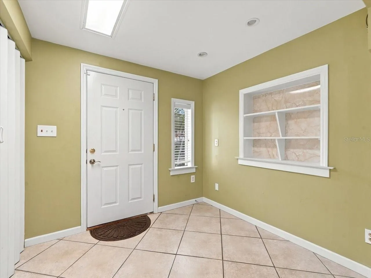 Back door off family/flex room with built in shelving