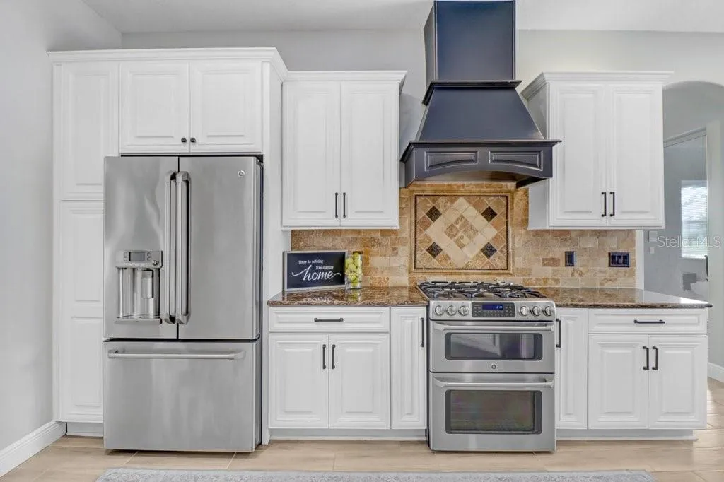 Custom Kitchen hood with stainless steel appliances