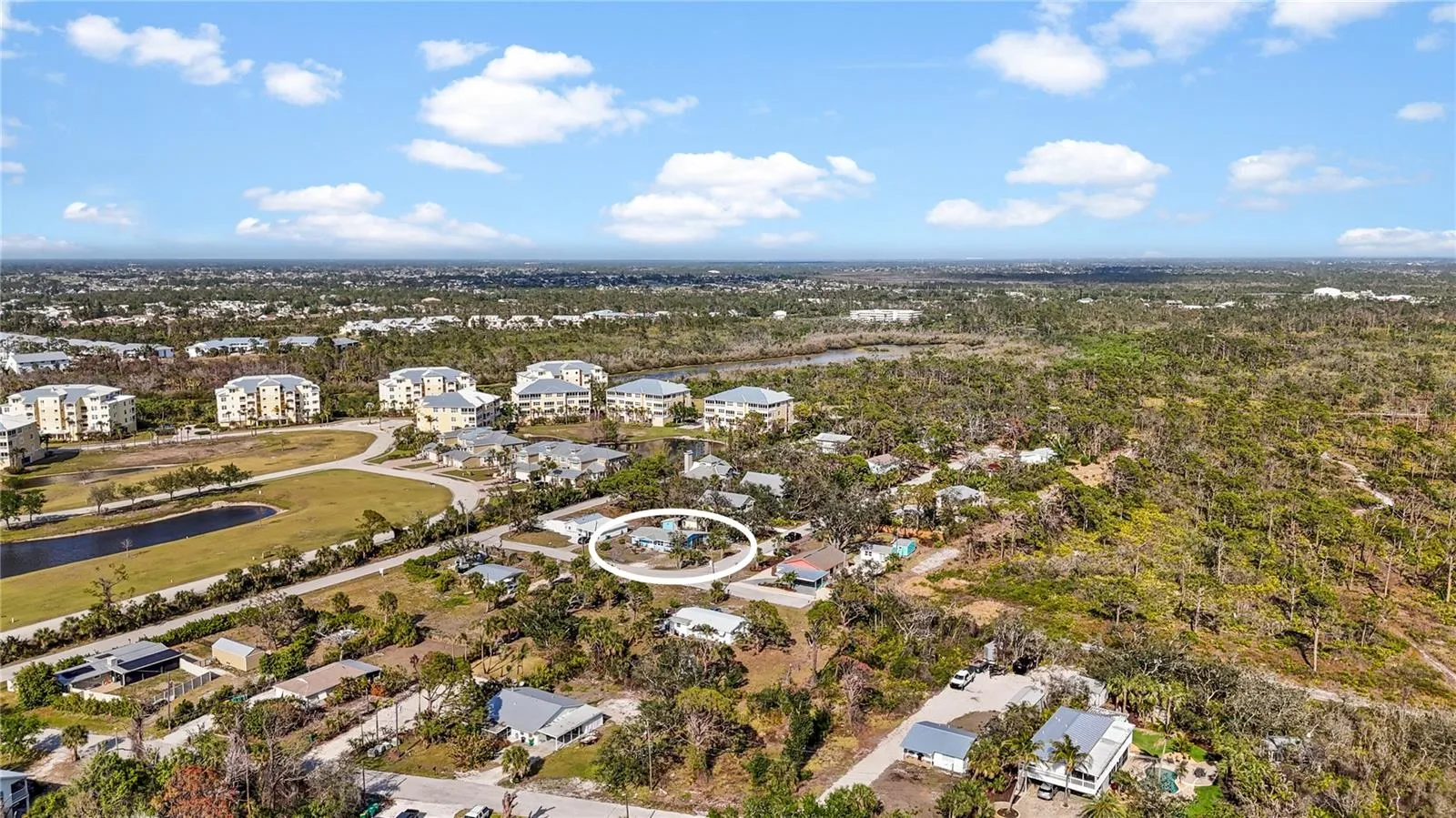 The large buildings to the north are The Hammocks, and the forested area to the south is portion of the 225 acre Amberjack Environmental Preserve.  At the end of the road is a gate where you can enter the Preserve to hike the trails.