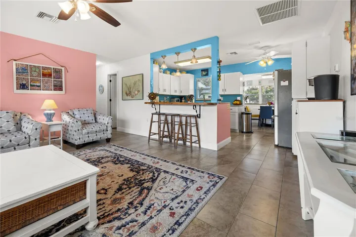 It has an open floor plan in the living area with a counter that peeks into the kitchen.  The dining area in the rear has views of the yard.