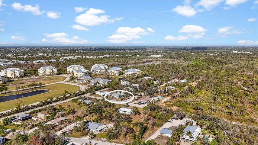 The large buildings to the north are The Hammocks, and the forested area to the south is portion of the 225 acre Amberjack Environmental Preserve.  At the end of the road is a gate where you can enter the Preserve to hike the trails.