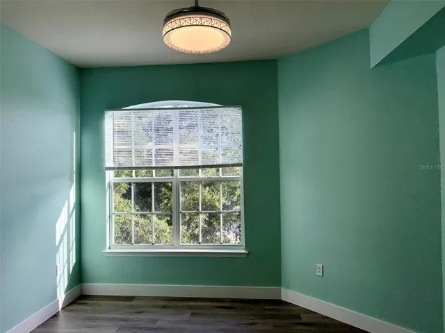 Primary bedroom with bright big window with new blinds, screen and lighting