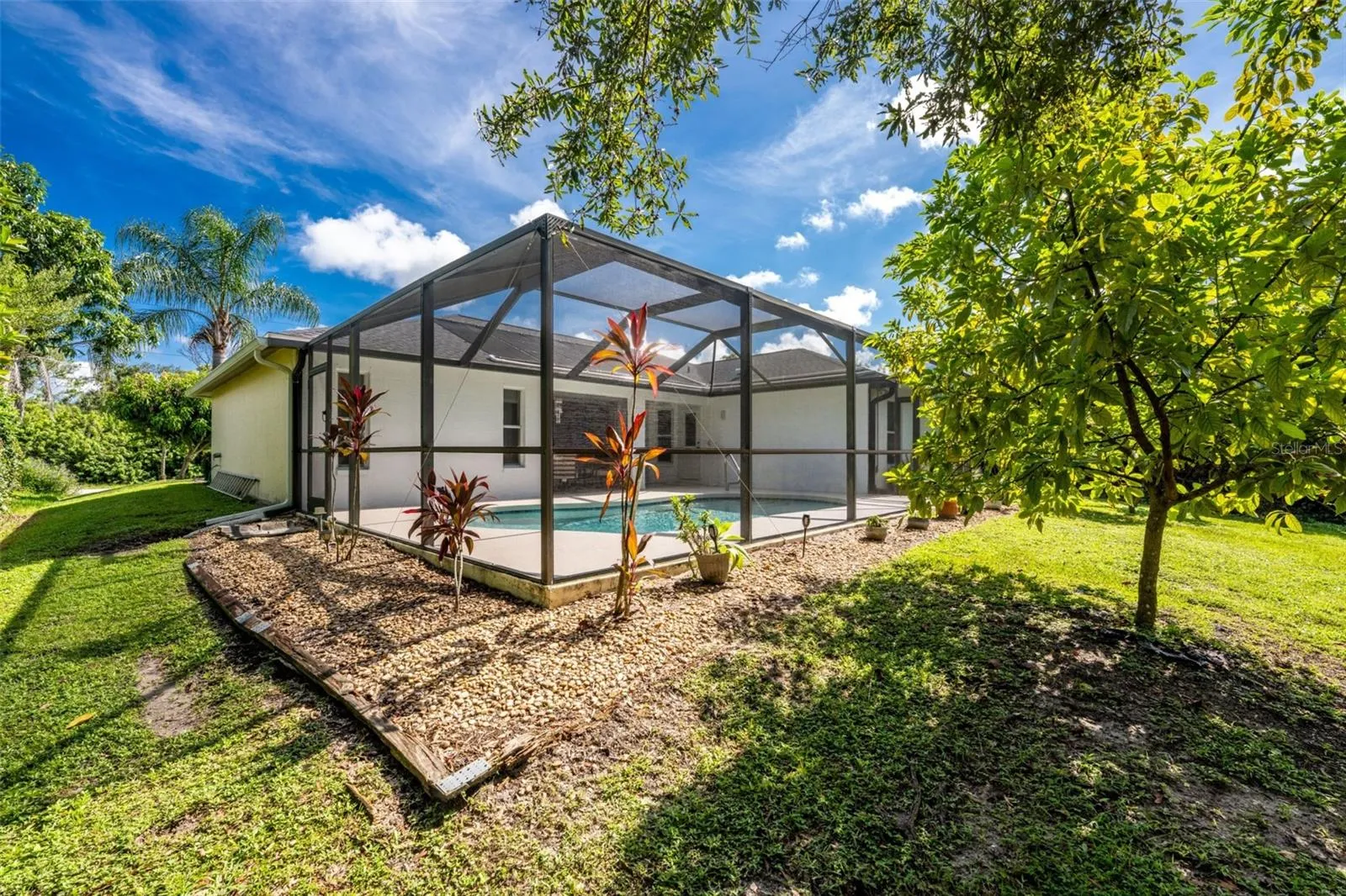 A view from your peaceful backyard into the lanai .