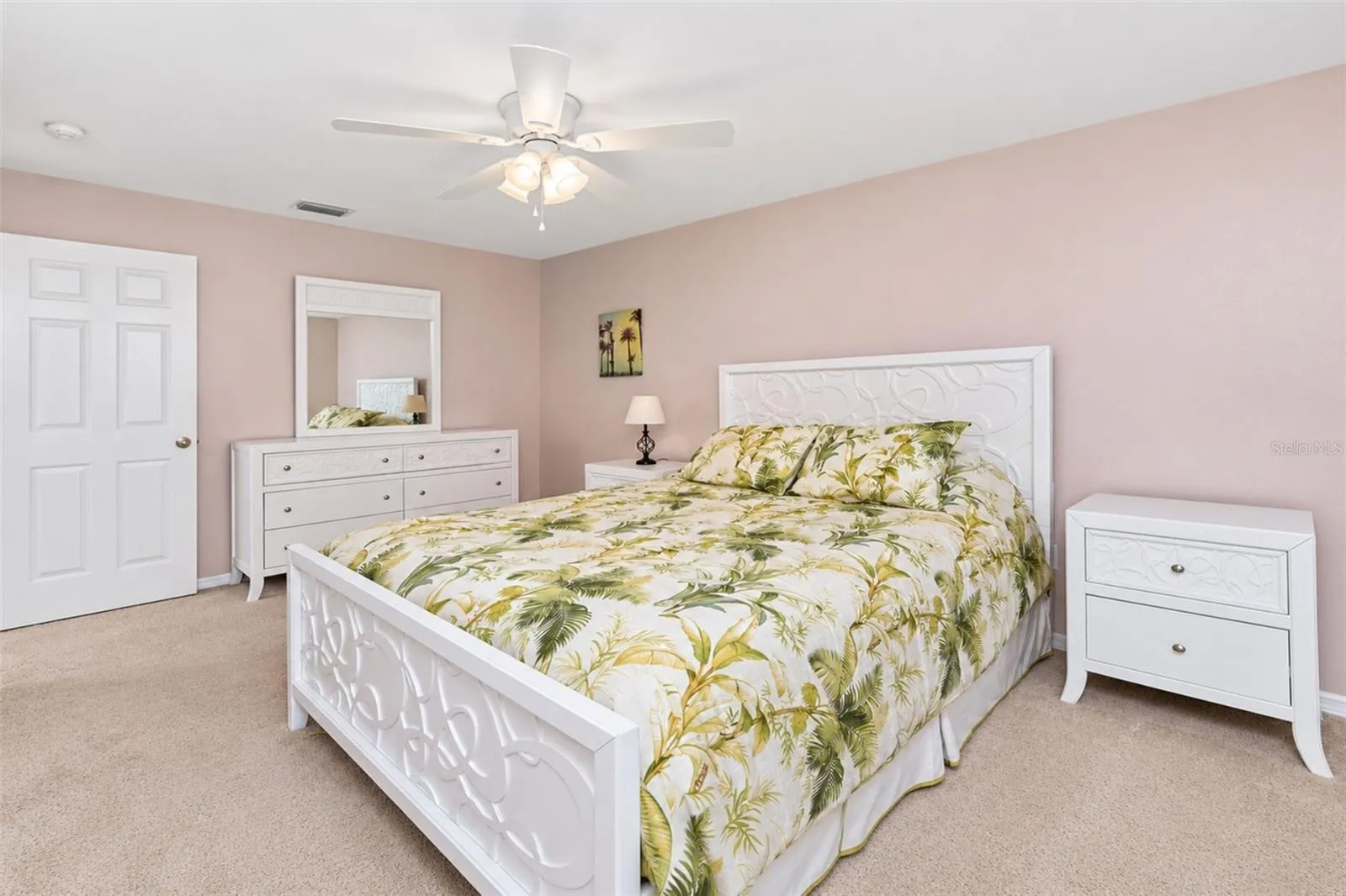 There's carpeted flooring and a ceiling fan.