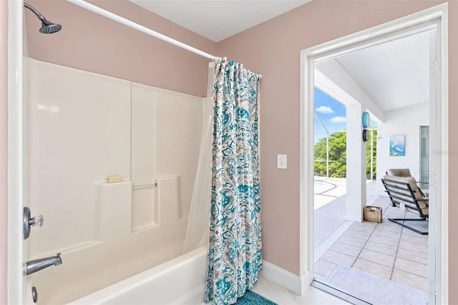 The guest/pool bathroom features a tub/shower combo and direct access to the lanai & pool.
