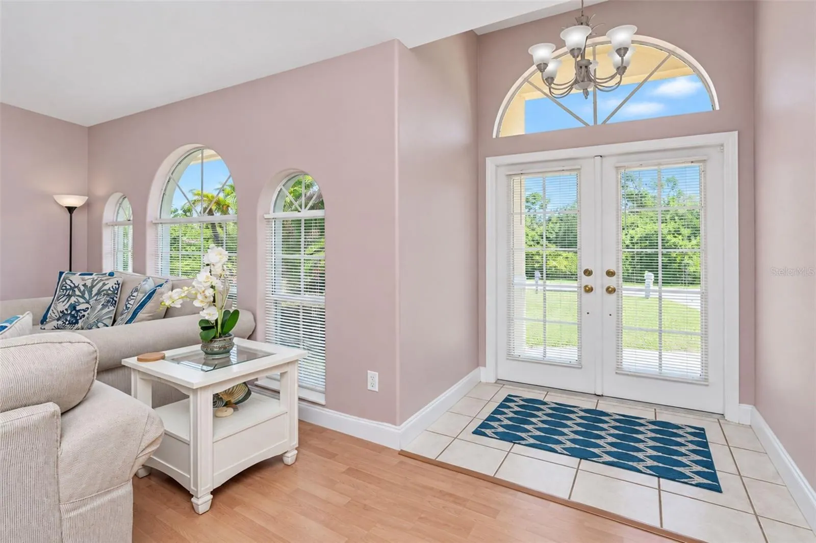 The foyer has tiled flooring and plenty of natural lighting.