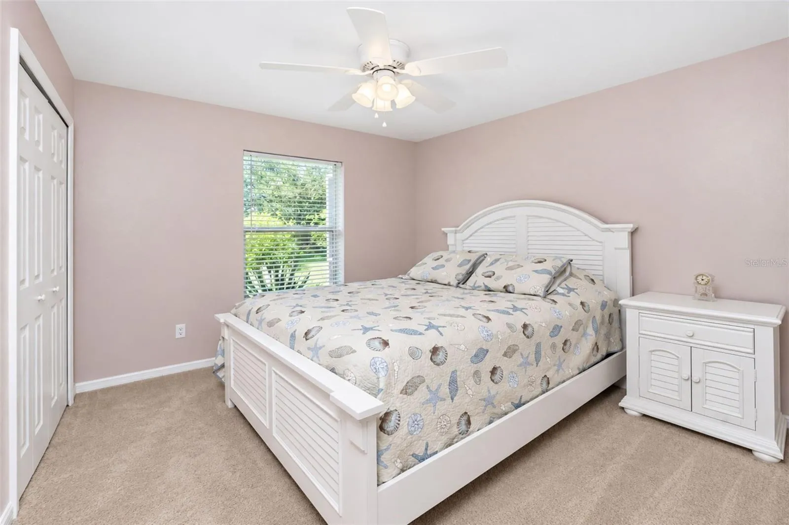 Bedroom 3 features carpeted flooring and a ceiling fan.