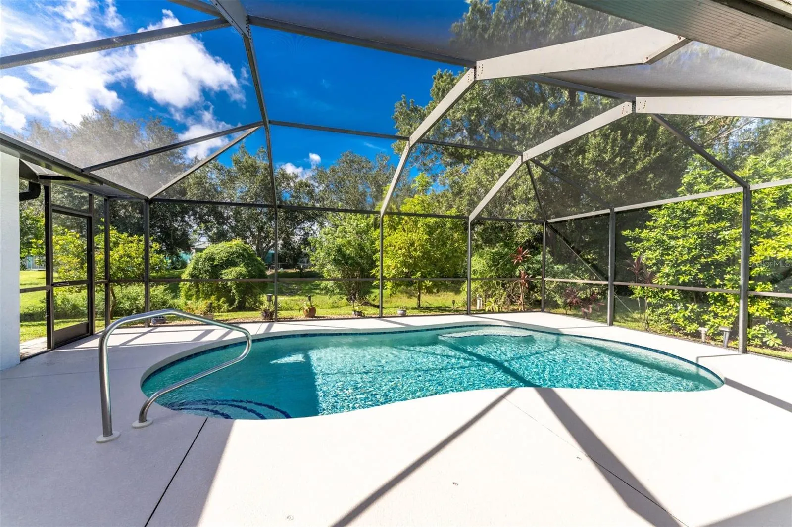 The pool is solar heated, southern facing and backs to a greenbelt for added privacy.