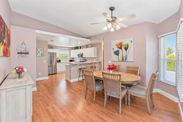 The dining area has laminate flooring and a ceiling fan.