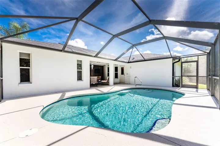 A view looking across the pool to the covered lanai.