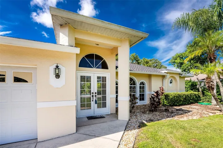The covered front entry and double glass doors are inviting.