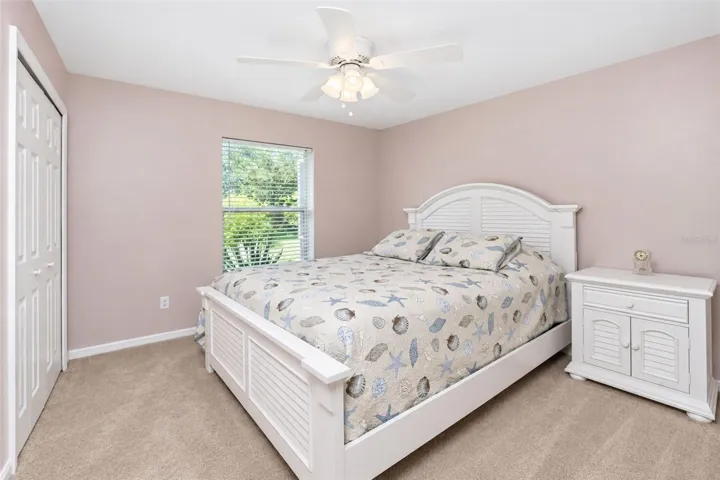 Bedroom 3 features carpeted flooring and a ceiling fan.