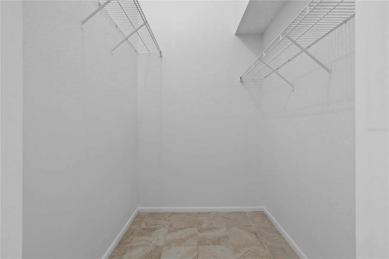 One of 2 primary walk-in closets