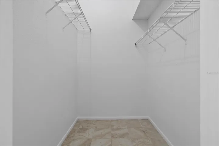 One of 2 primary walk-in closets