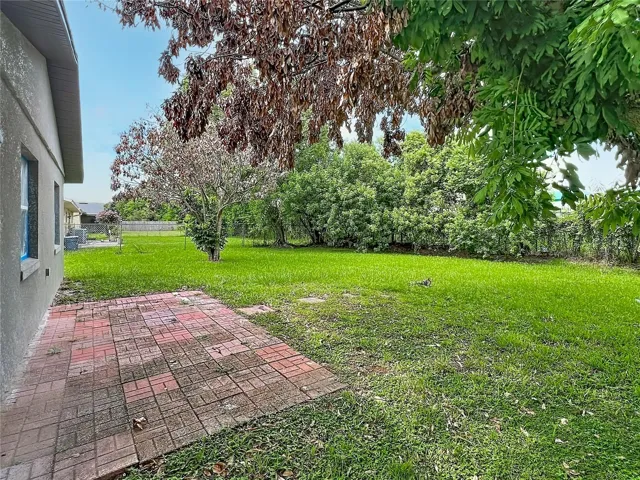 Brick-paver patio overlooking the spacious backyard