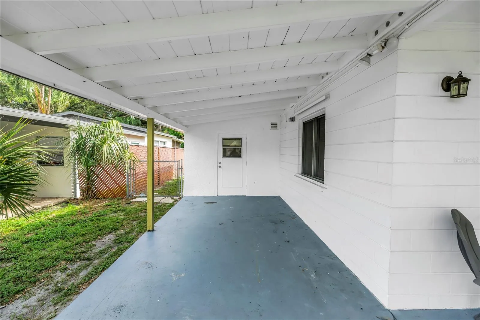 Carport with entrance to Florida room