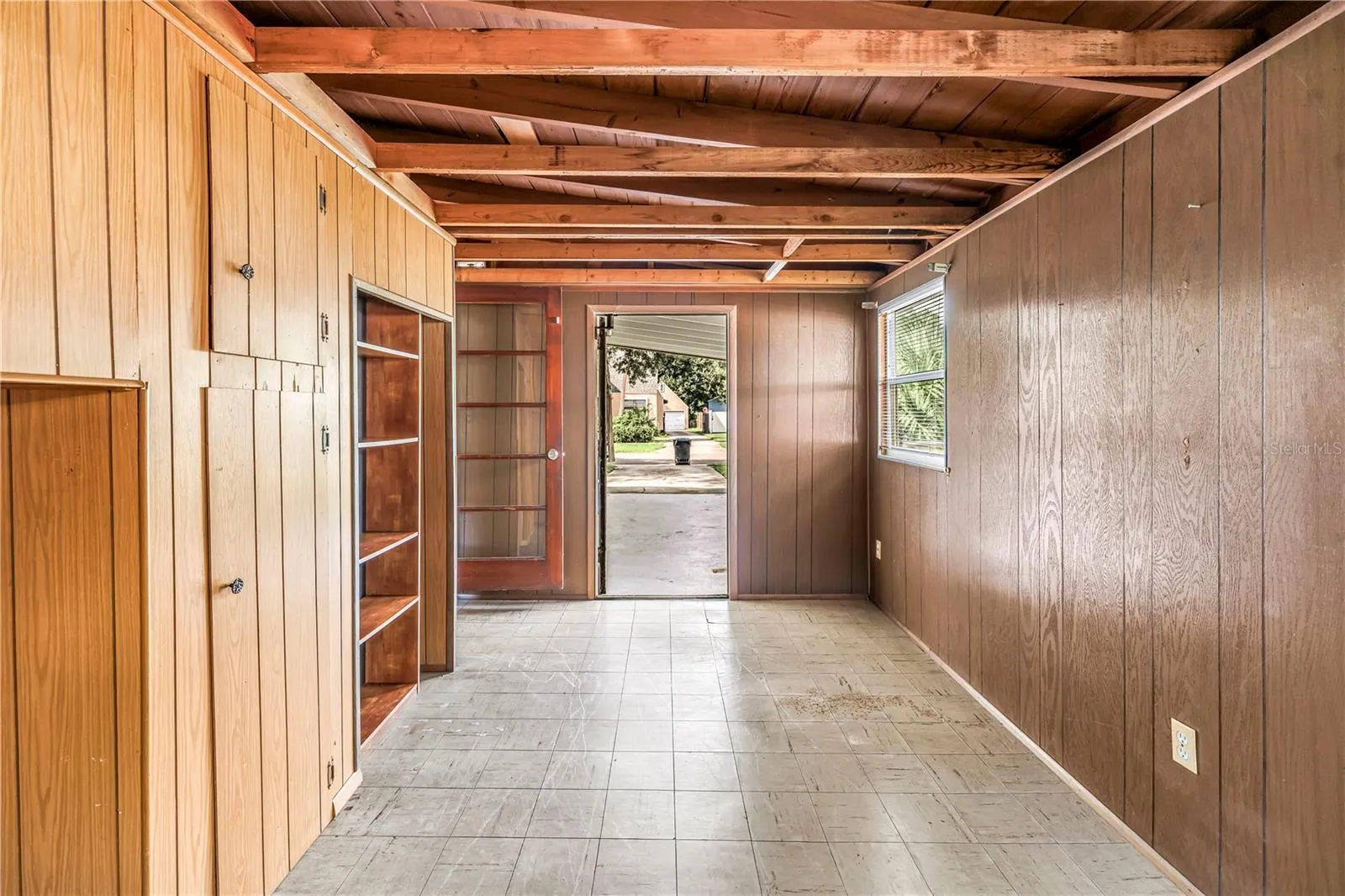 Exit to carport. Florida Room/Bonus Room/ Could be 3rd bedroom with a little tlc. Comes with brand new portable HVAC
